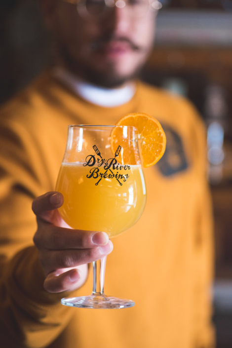 Person holding a beer glass