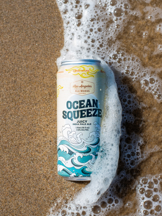 Can of Ocean Squeeze beer with waves forming around