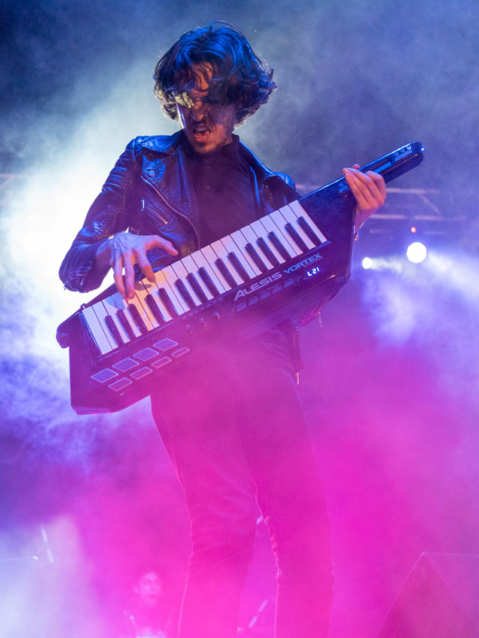 Man playing keytar on stage